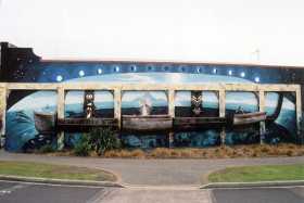 A mural in Whakatane depicting Captain Cook on a waka in front of Whale Island - it represents the coming together of the Maori and the Pakeha (Europeans) and celebrates 150 years of the Treaty of Waitangi