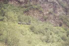 The Fl&sring;m train looks like a toy compared to the mountains it passes by